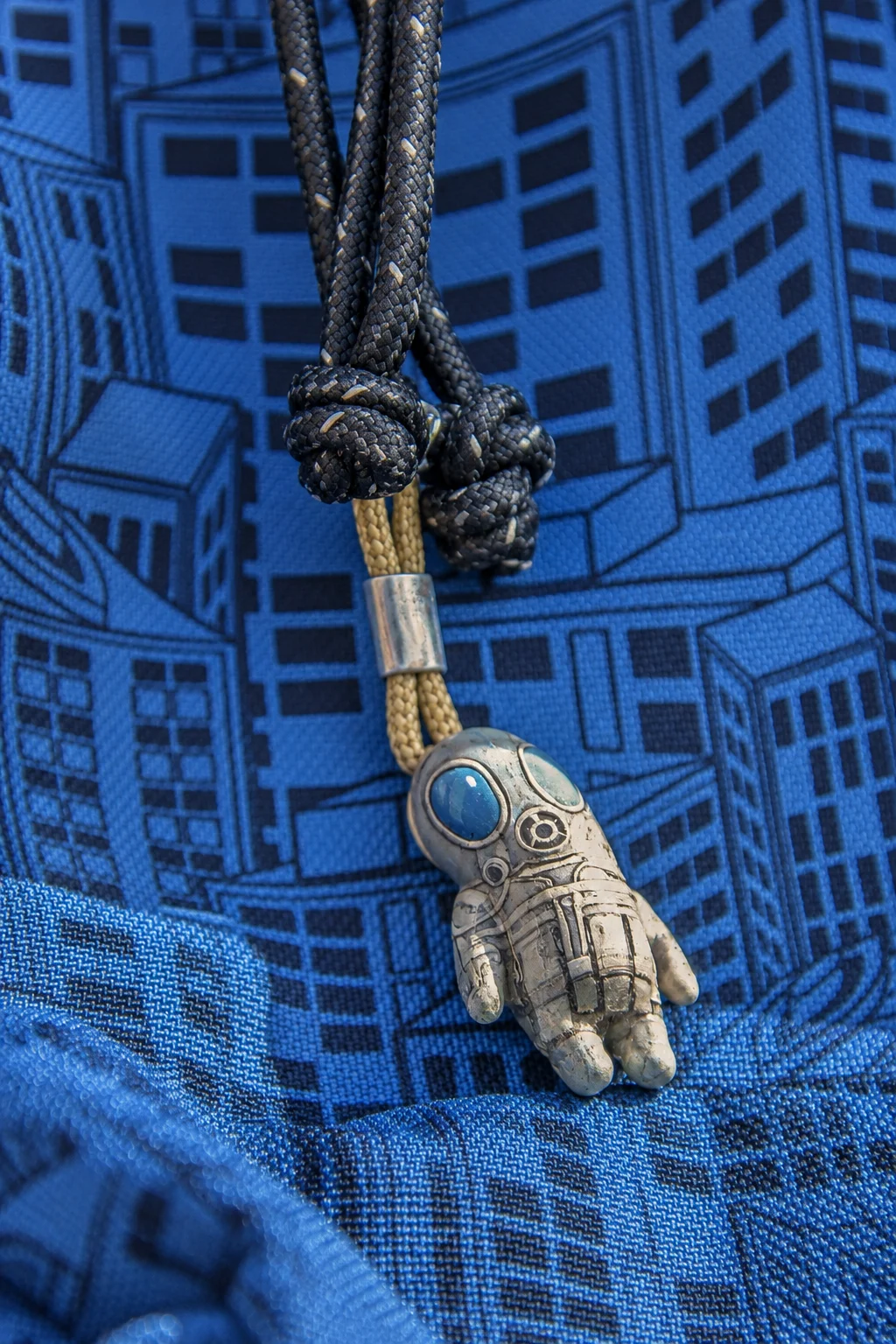 Lil SAS charm hanging from a blue bag